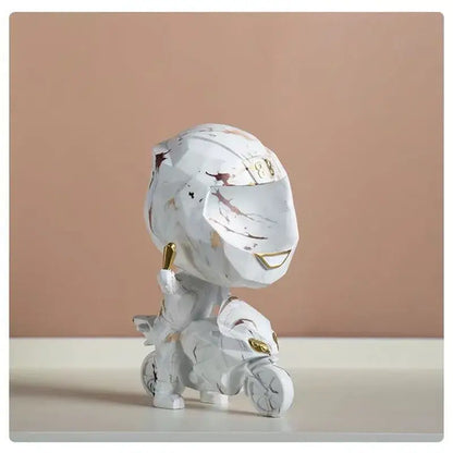 White marble-effect motorcycle rider figurine with gold accents and stylized helmet for decorbites decorative key storage