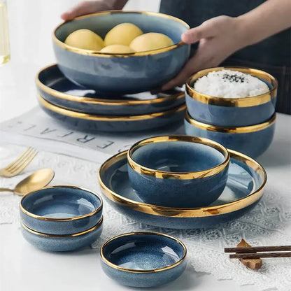 Blue gradient ceramic plate set featuring gold rims ideal for elegant dining room dinnerware use