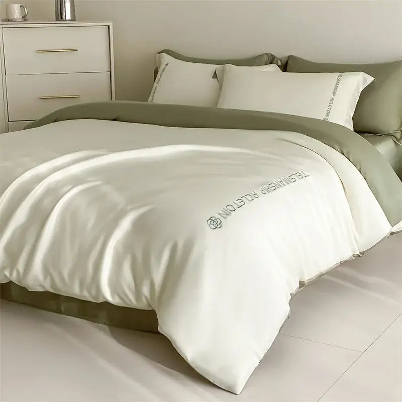 Cream-colored satin duvet cover with sage green piping and teasman picton embroidery in decorbites cotton solid bedding set