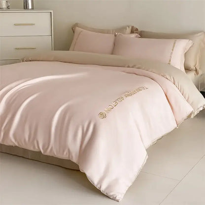 Blush pink satin duvet cover with gold embroidered logo and rose motif in decorbites cotton solid color bedding set