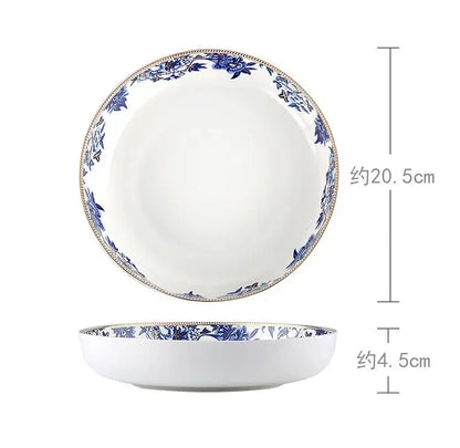 A white ceramic bowl with blue floral pattern and gold trim from decorbites blue lotus dinnerware set