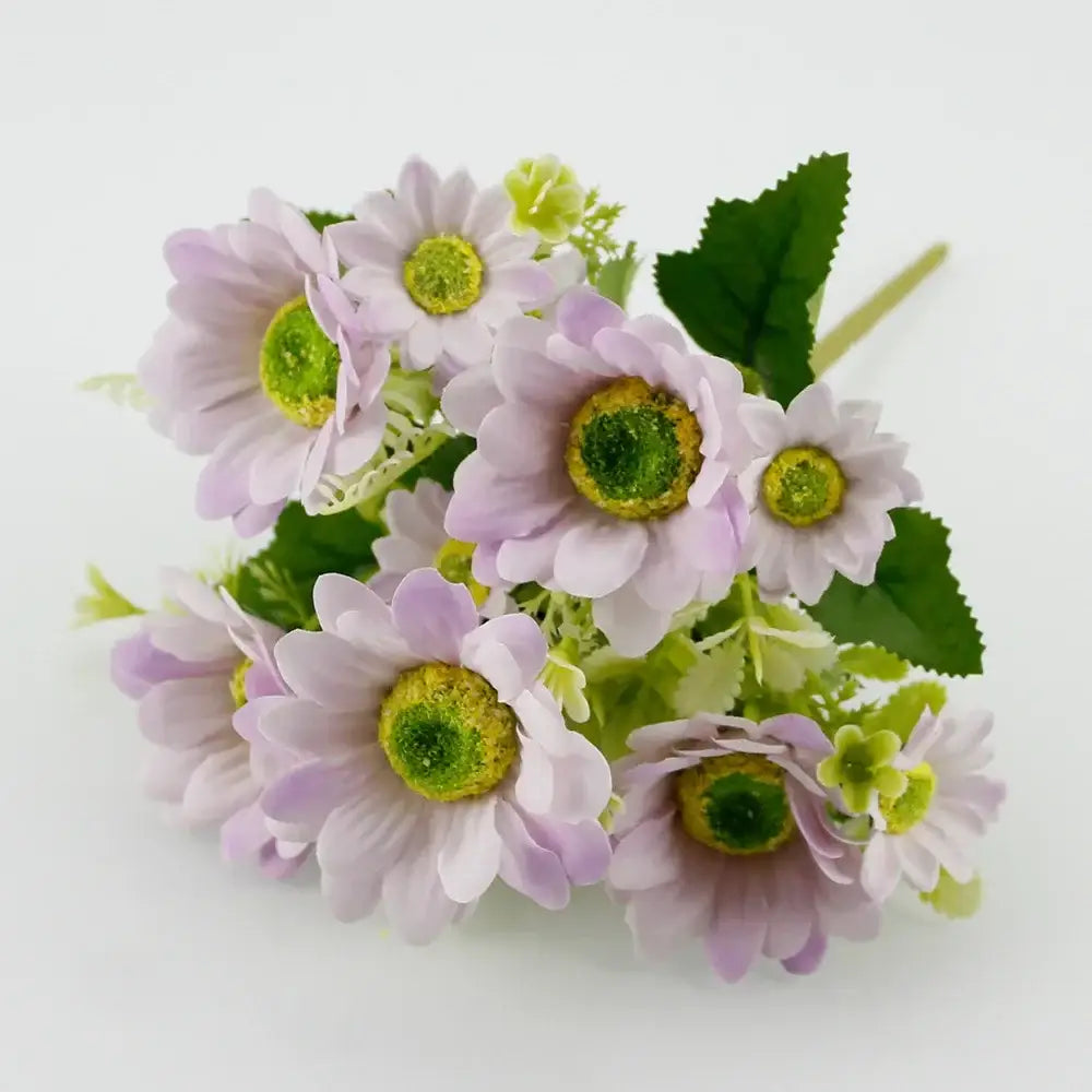 A delicate bouquet of lavender pink silk fake flowers with green centers paired with blue peony and tea rose decor