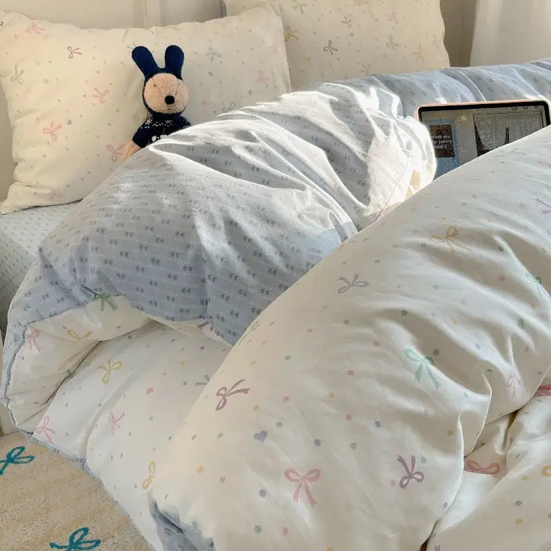 Soft pastel-colored quilt with bows and polka dots in muted pinks blues and greens for decorbites cotton cartoon bedding set
