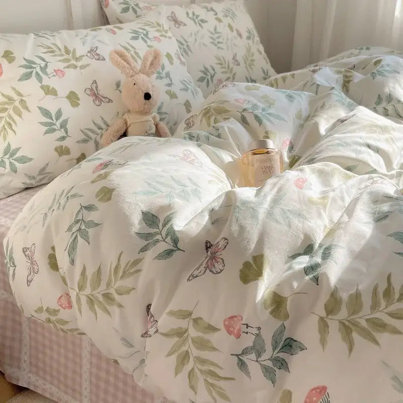 A cream-colored cotton cartoon printed bedding set with delicate green leaves and pink butterflies for bedroom decor