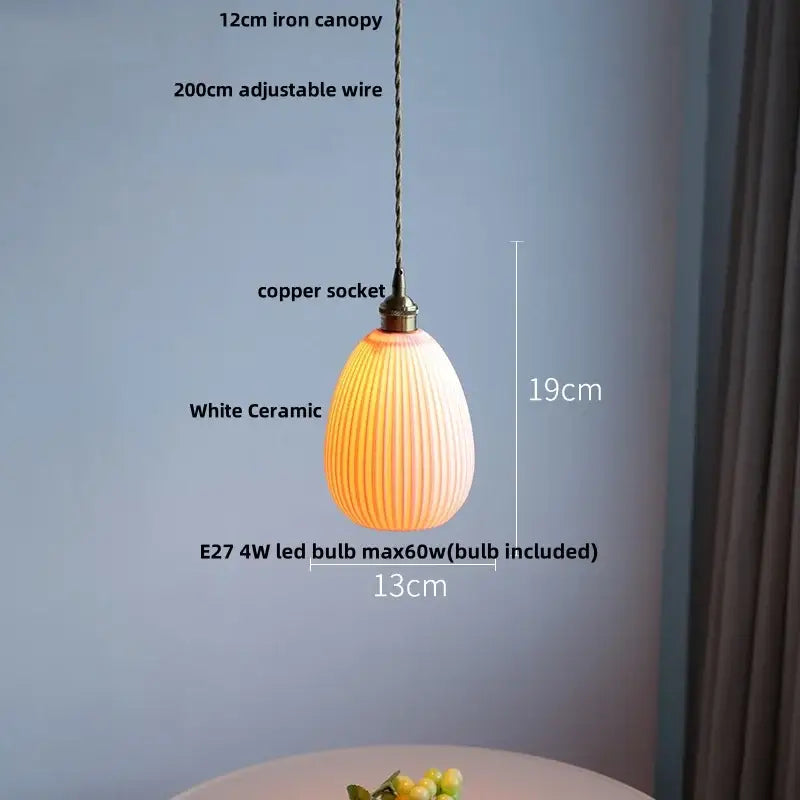 White ceramic led pendant lamp with vertical ridges and warm glow by decorbites ceramic led pendant design