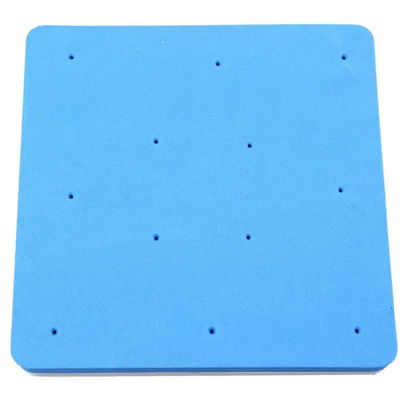 Blue square foam cake shaping mat with evenly spaced perforations for precise cake shaping and dessert preparation