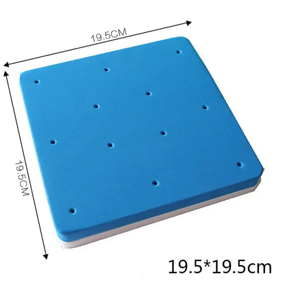 Blue square foam cake shaping mat with white underside and evenly spaced holes for precise cake shaping