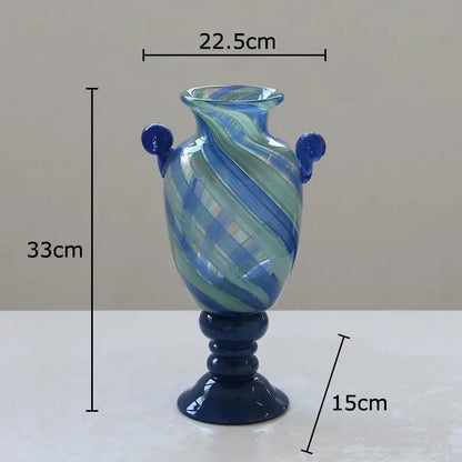 A tall blue stripe glass swirl vase with dark blue handles and pedestal base for living room hydroponic plant decorbites