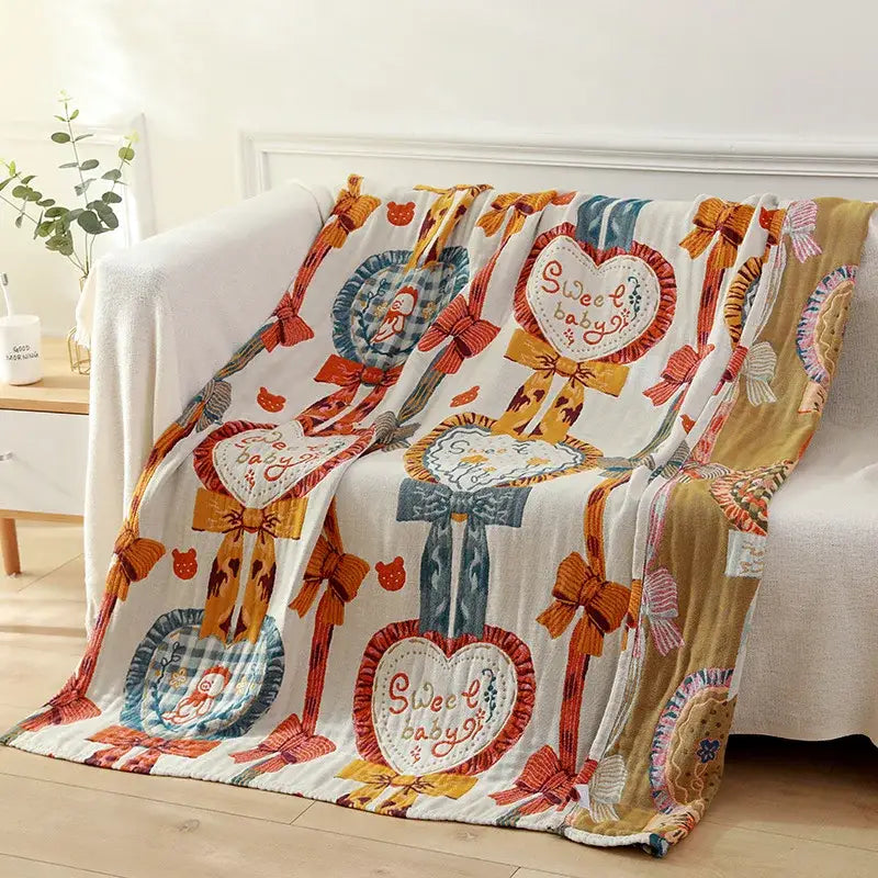 Cozy white gauze cotton bath towel featuring sweet baby heart motifs with bows and cartoon characters in blue, red, and orange tones