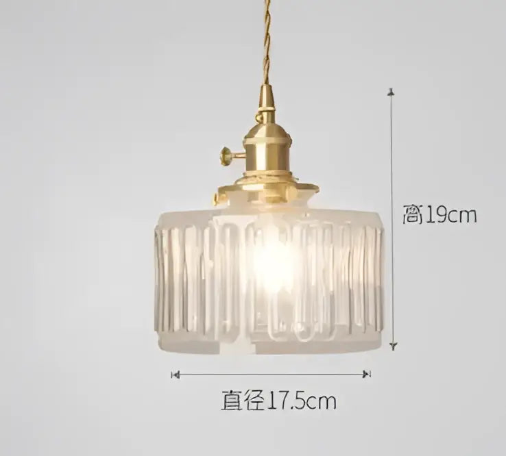 A vintage-style decorbites pendant light with a brass fixture and blue translucent ribbed glass shade for bedroom decor