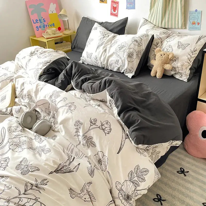 A cozy bedroom with black and white floral decorbites cloud cotton printed bedding sets featuring dark gray sheets