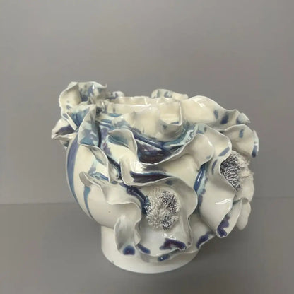 A white ceramic fold pattern vase with intricate blue glaze and ruffled details by decorbites handmade porcelain for decor