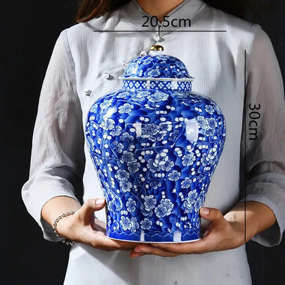 Blue and white porcelain ginger jar with intricate floral patterns and gold lid knob for sealed storage tank use