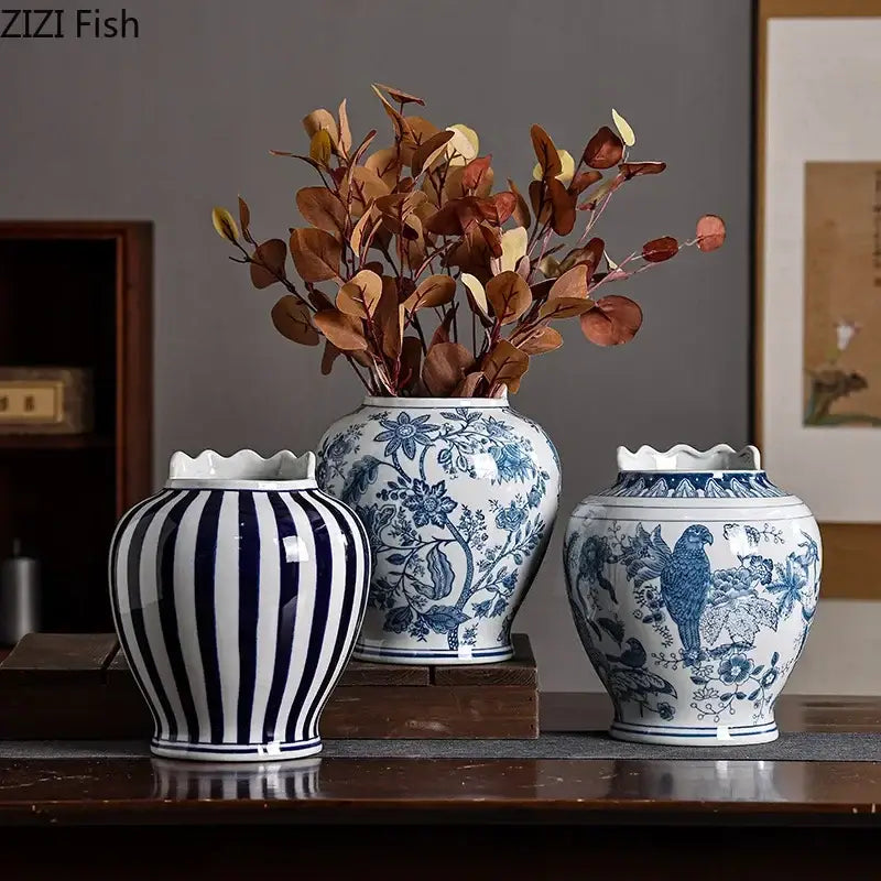 Three blue and white porcelain vases with artificial flowers featuring stripes floral and bird motifs for desk decor