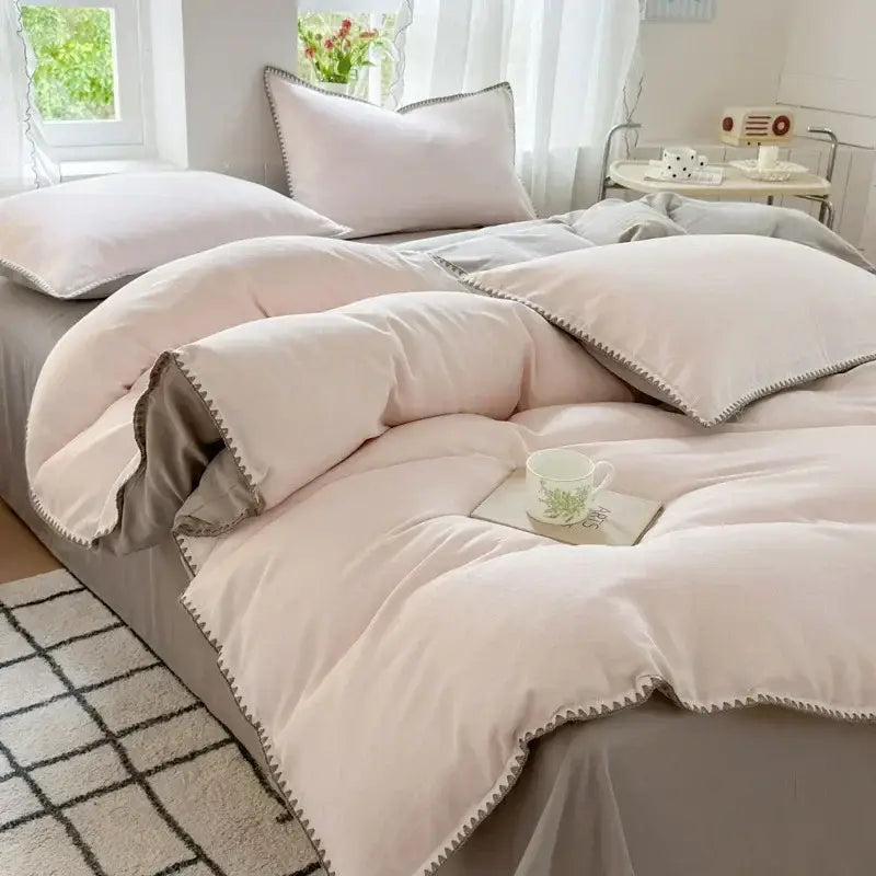 Blush pink and gray cotton bedding set with quilted zigzag stitch and plush texture for bedroom comfort