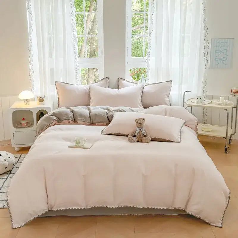 Blush pink and gray cotton edge embroidery bedding set with soft pom-pom trim from decorbites cotton edge collection