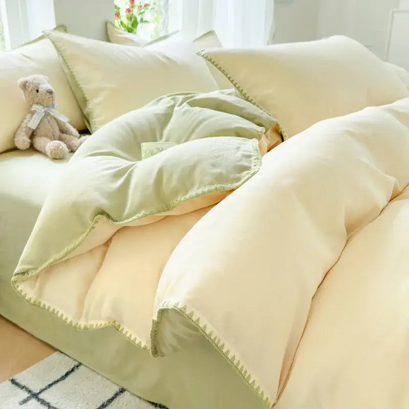 Soft cream-colored quilted duvet bedding set with subtle sage green trim and decorbites cotton edge embroidery