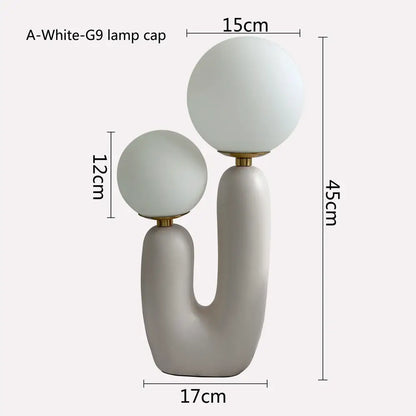 Modern minimalist blush pink and white glass ball led table lamp with frosted glass shades on matte gray ceramic base for bedroom decorbites glass ball