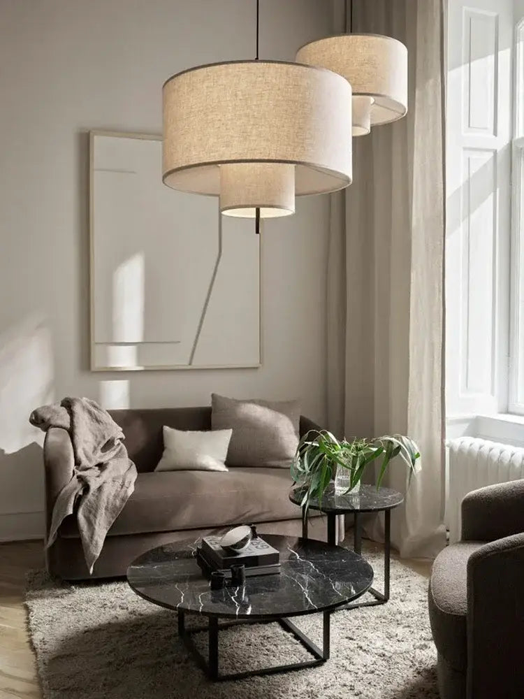 Beige linen tiered pendant lights with modern stacked cylindrical design for dining room decorbites bohemia wabi sabi