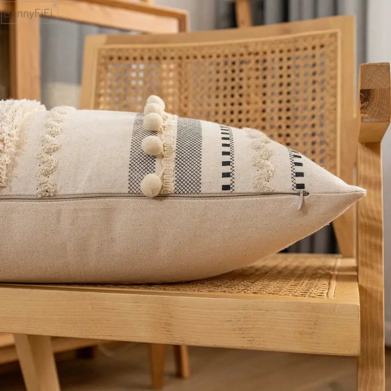 Beige linen cushion cover with black and white geometric stripes cream pom-poms and frayed lace trim decorbites bohemian beige