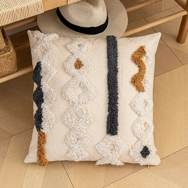 Cream-colored cushion cover with textured tufted geometric patterns in black and caramel brown for home decor by decorbites bohemian beige