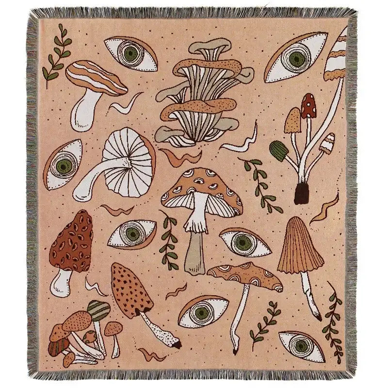Beige woven bohemian camping blanket by decorbites featuring whimsical mushroom and eye patterns with fringed edges
