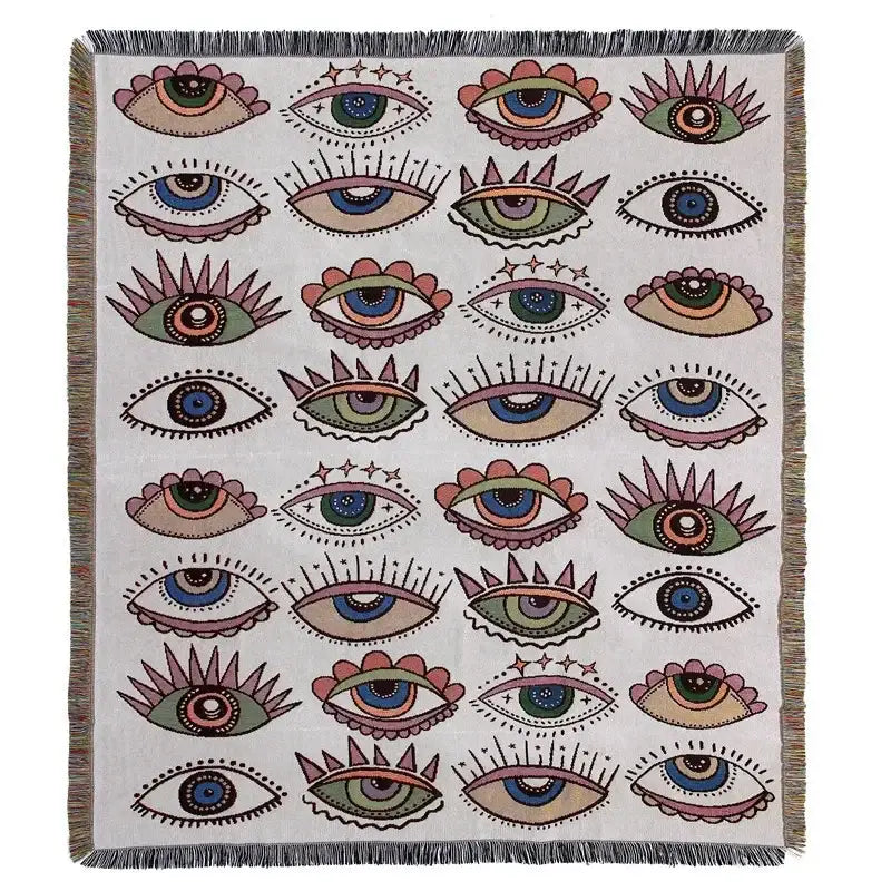A cream-colored decorbites bohemian camping blanket with yellow sun pattern and fringed edges for living room decor