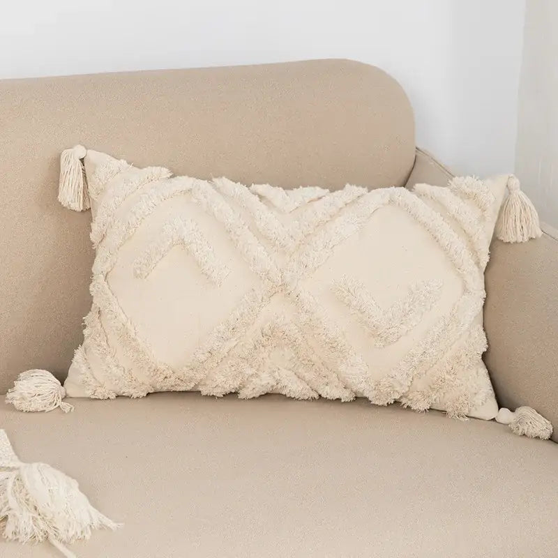 Cream-colored rectangular cushion cover with textured fringed fabric and tassels for decorbites bohemian tassel living room decor