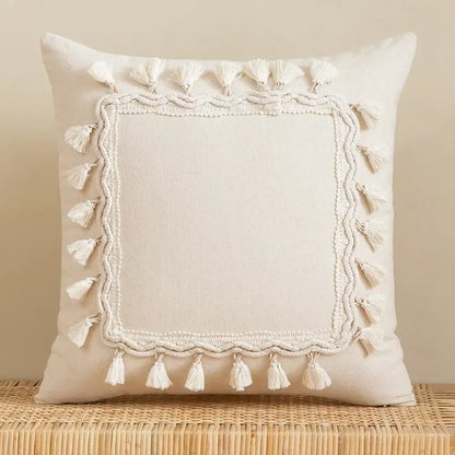 Cream-colored square cushion cover with textured embroidered border and white tassels for living room decor decorbites bohemian tassel