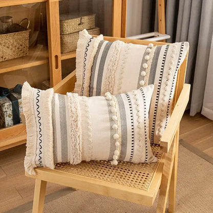 Two rectangular cream and gray striped cotton cushion covers with fringed edges and white pom-poms decorbites bohemian cotton decor