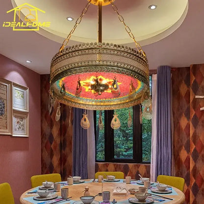 Gold-toned bohemian exotic stained pendant lights with intricate metalwork and red mosaic glass for dining room decorbites