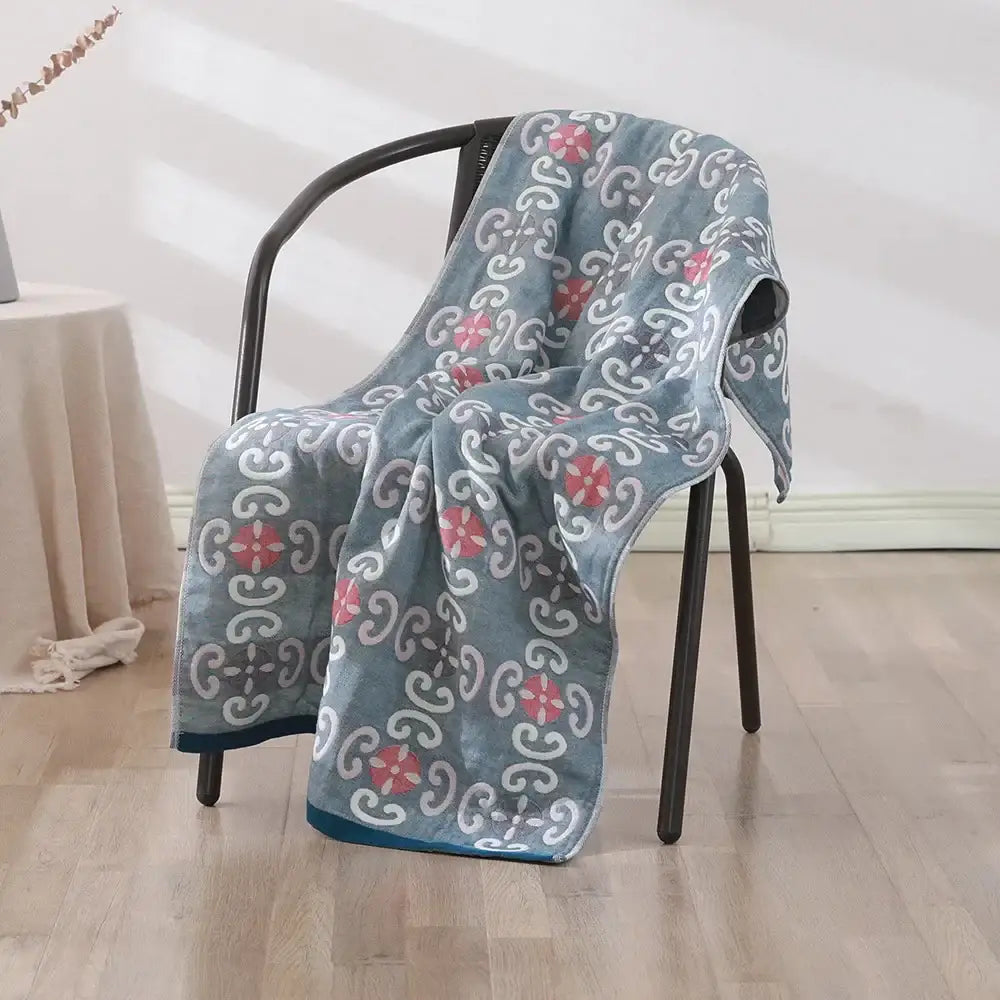 A soft plush blue bohemian floral cotton bath towel with pink and white motifs for decorbites bathroom wrap