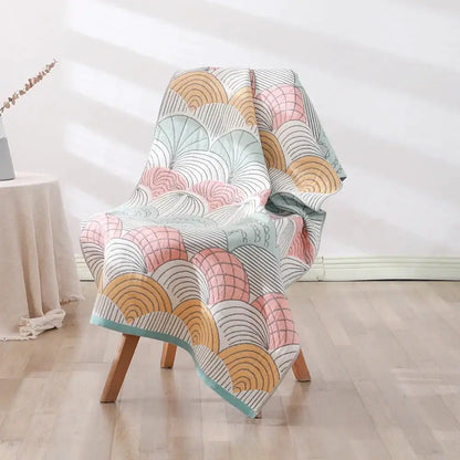 A soft quilted throw blanket with pastel fan motifs in pink beige and mint green for decorbites bohemian floral bath towel