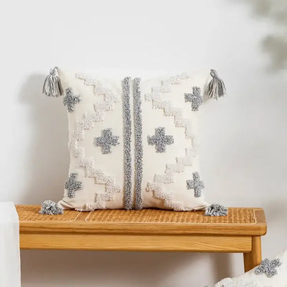 Cream-colored cushion cover with textured gray geometric patterns and tassels by decorbites geometric tufted pillow cover