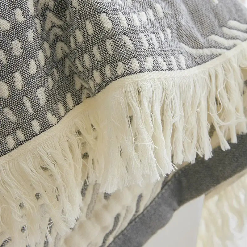 Bohemian cotton throw blanket in gray and white woven cotton with textured ovals and off-white fringe decorbites bohemian cotton