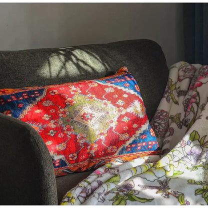 Vibrant red and blue bohemian jute linen pillow covers with geometric and floral designs on dark gray sofa decorbites bohemian jute