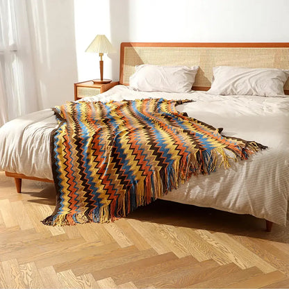 Vibrant decorbites bohemian knit tassel blanket with multicolored zigzag pattern in yellow blue orange and brown hues