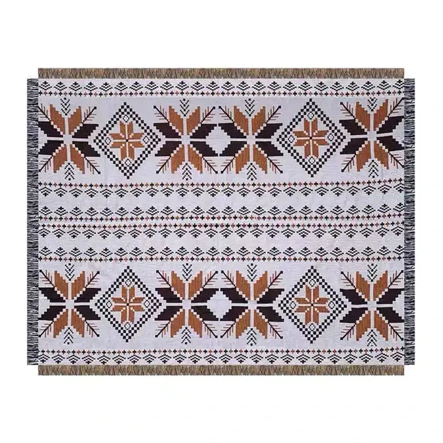 White woven decorbites bohemian knit throw blanket with black and burnt orange geometric pattern and fringed edges