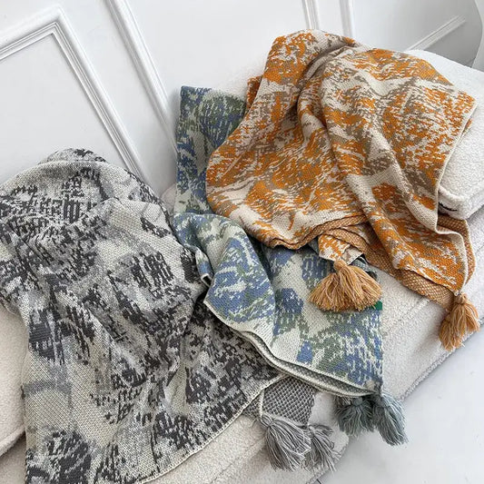 Three decorbites bohemian knitted blankets with earthy tones, tassels, and abstract patterns for bedroom throw decor