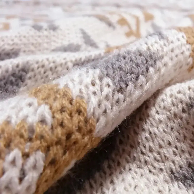 A cozy bohemian knitted sofa blanket in cream gray and mustard tones with textured pattern for bedroom decorbites decor