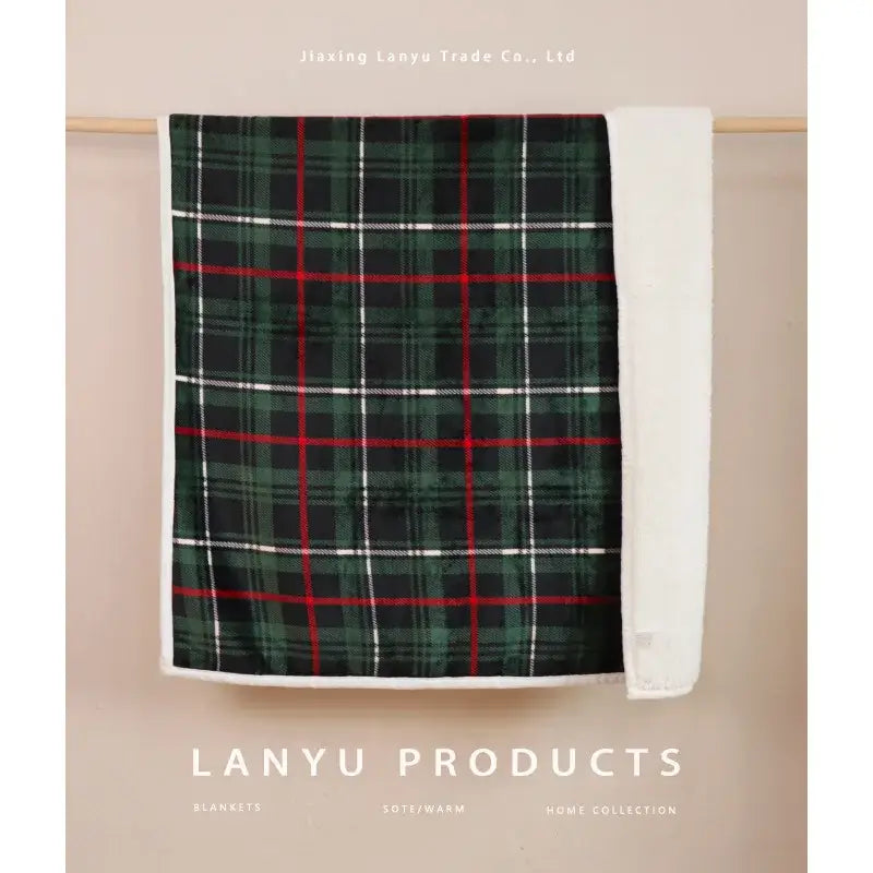 A cozy green red and white plaid coral fleece sofa blanket with soft fleece lining for winter comfort
