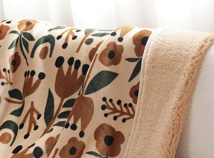 Cozy cream coral fleece sofa blanket with plush texture and earthy floral pattern perfect for winter use