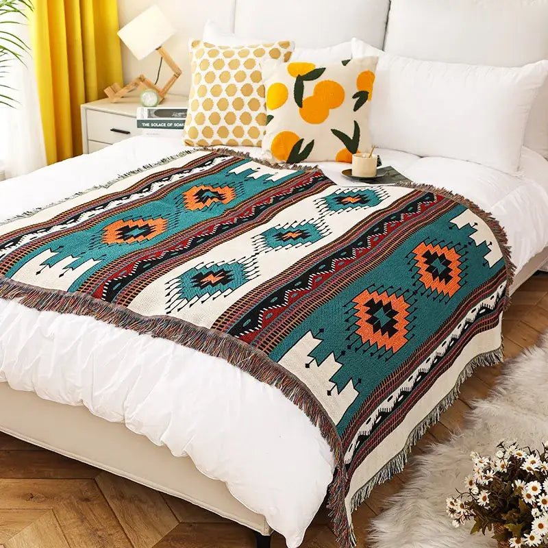A decorbites bohemian throw blanket with a vibrant orange geometric pattern and fringe for bedroom decor