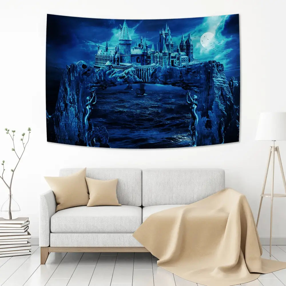 Blue-toned hogwarts art tapestry featuring intricate moonlit castle and rocky cliffs for bohemian bedroom decor