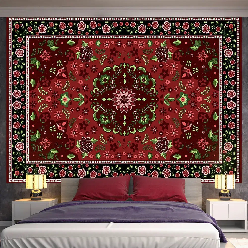A bohemian red and gold indian mandala tapestry with intricate floral patterns used as bedroom wall decor