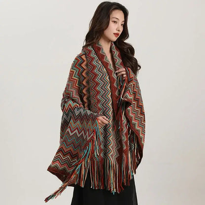 A vibrant bohemian wavy fringe shawl knit with zigzag patterns in red teal and brown for living room use
