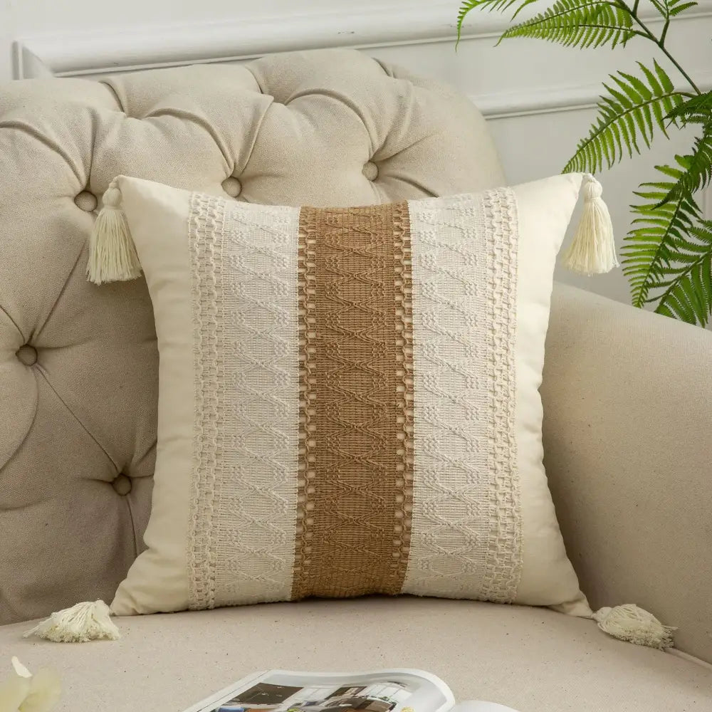 Cream-colored pillow cover with tan woven stripe, cream lace, and tassels for decorbites bohemian style fringed decor