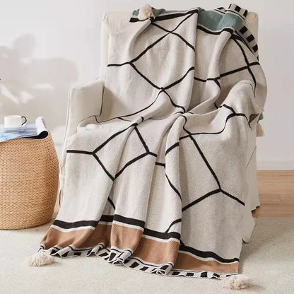 Cream-colored bohemian tassel knit blanket with black geometric patterns and beige accents for living room decorbites decor
