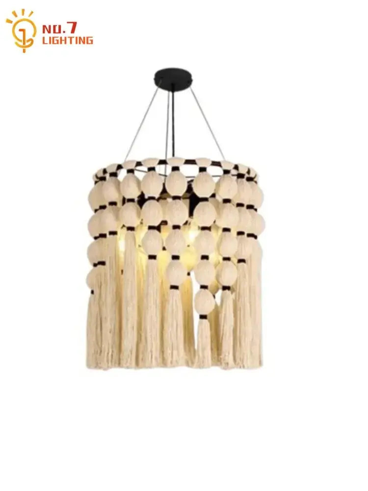 Beige macrame bohemian tassel pendant led light with wooden beads and tassels suspended by black cords from ceiling mount