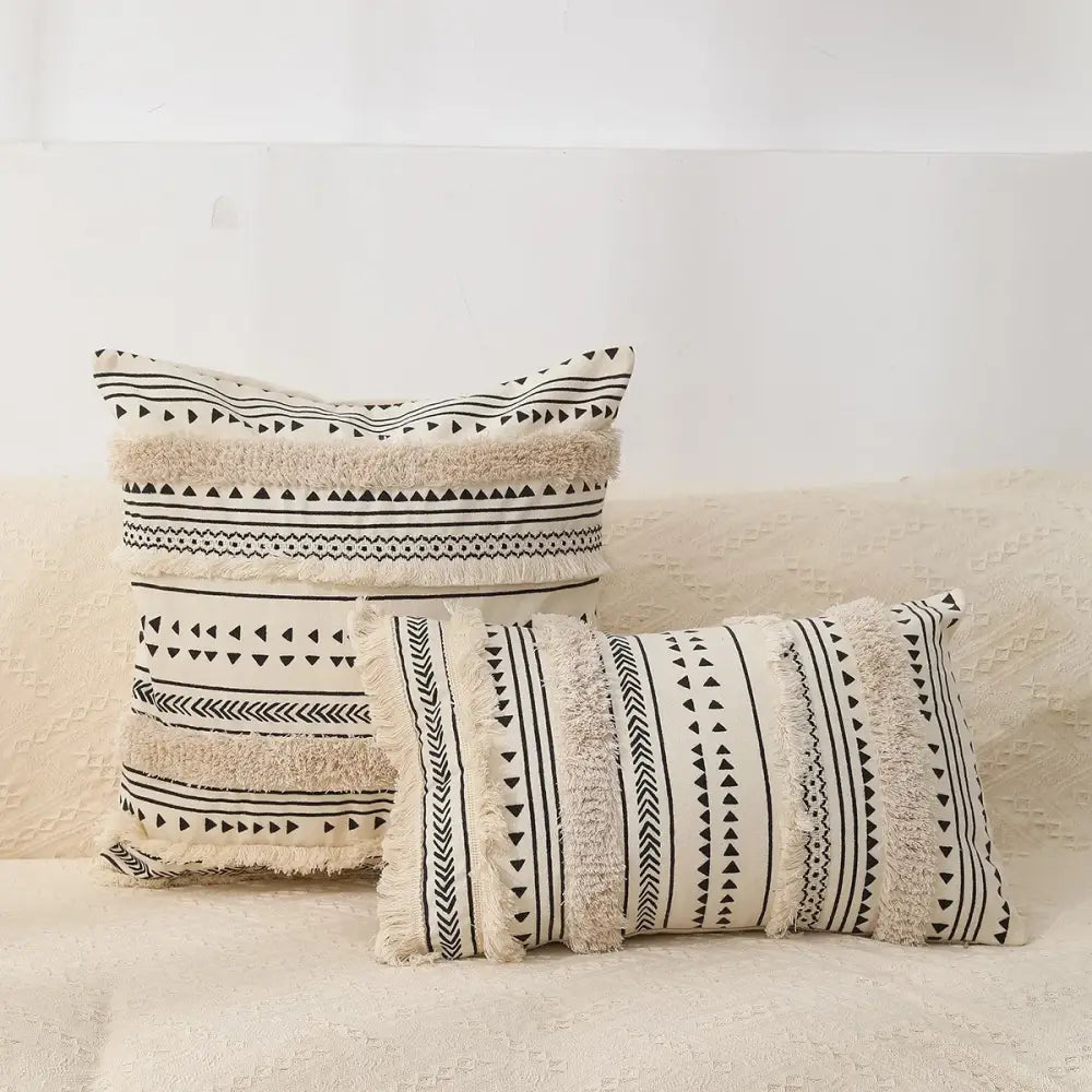 Cream-colored bohemian tufted tassel pillow case with black geometric patterns and fringed edges for living room decorbites decor